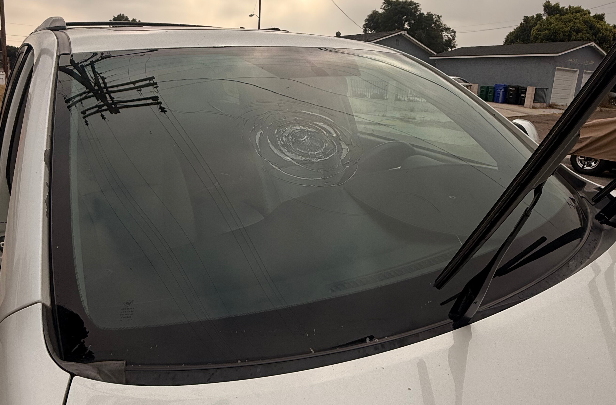Close-up of cracked windshield showing spreading fracture in Aliso Viejo