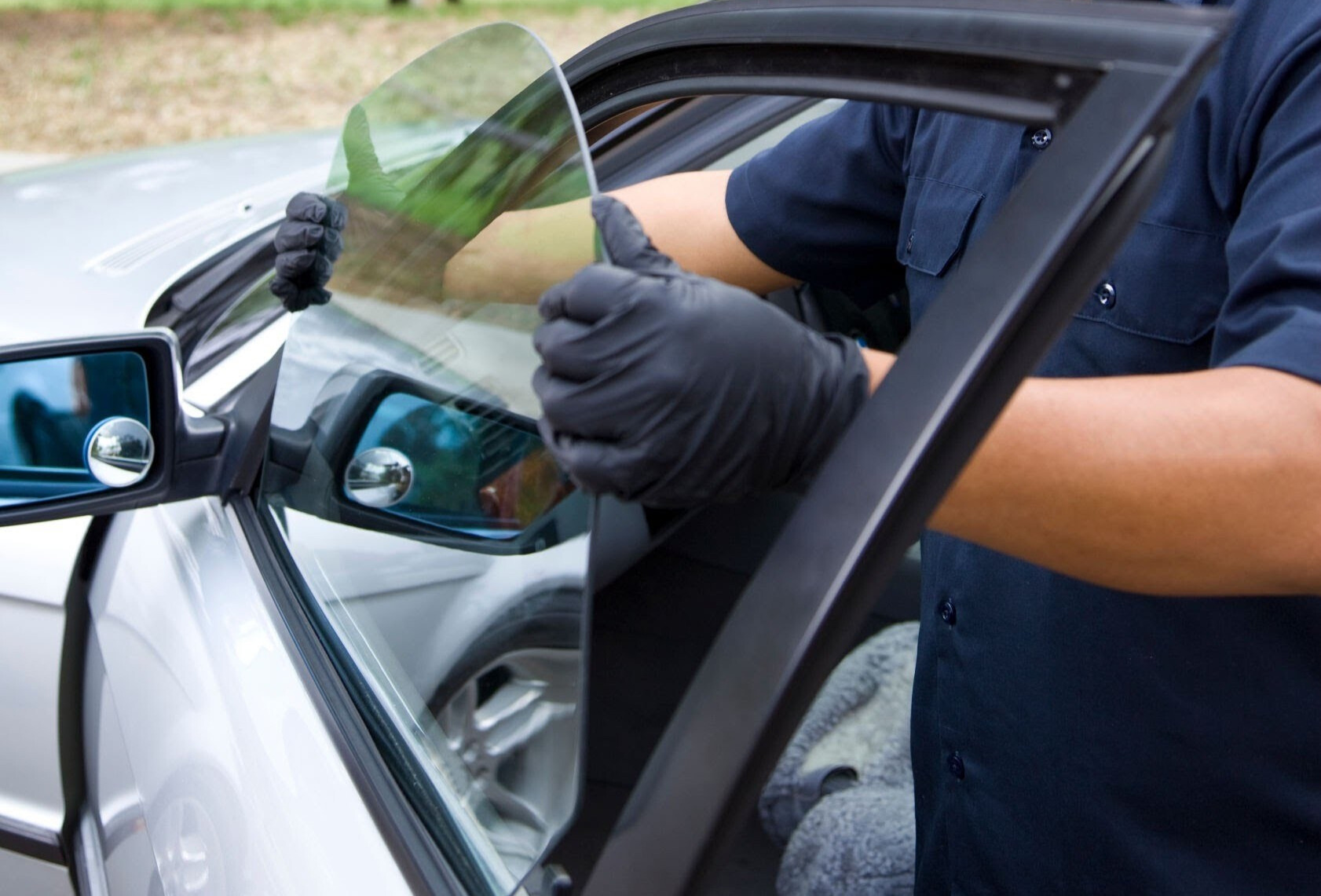 Auto glass technician replacing car door window and back glass in Ventura County